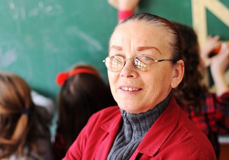 cute-lovely-school-children-at-clasroom-having-education-activities-with-senior-femal-teacher_BYuWQCA6Hi-1500x750