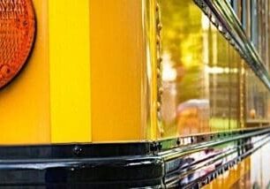 Side view of a yellow color bus with children