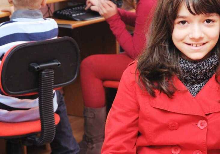 it education with children group  in school at computer science class learning leassons and practice typing