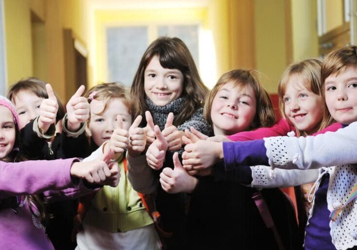 happy school girls running outdoor at sunny autumn day
