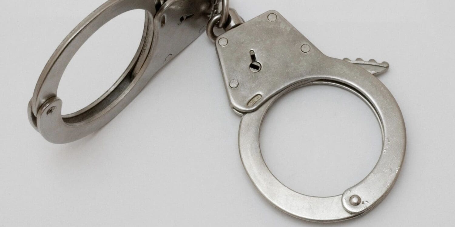 Close up shot of a handcuff with a white background